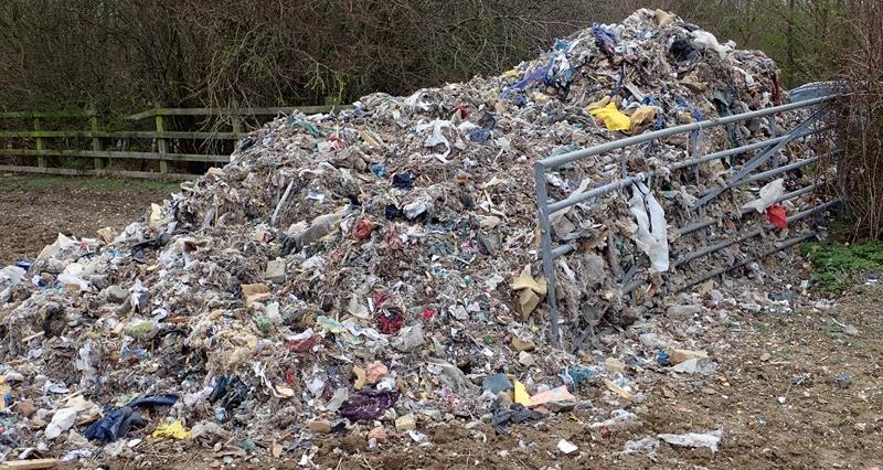 A pile of waste dumped in the gateway to a field