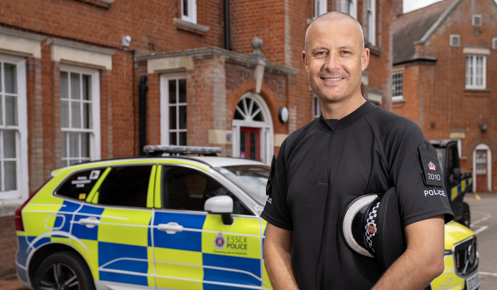 A police officer standing in front of a police car