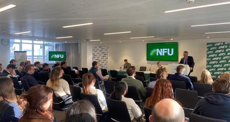 NFU Deputy President David Exwood talking to seated delegates from a lecturn in a conference room