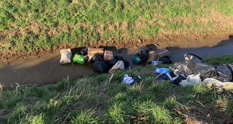 Fly-tipped waste in a river