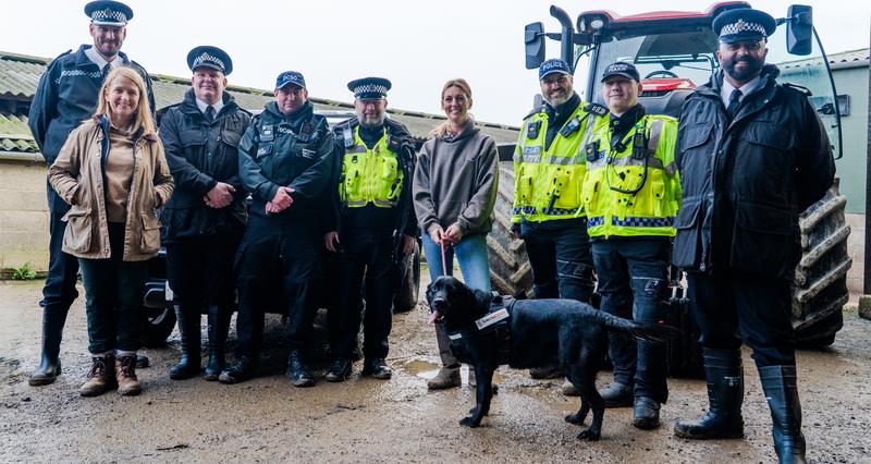 Police and the Police and Crime Commissioner standing in front of a tractor