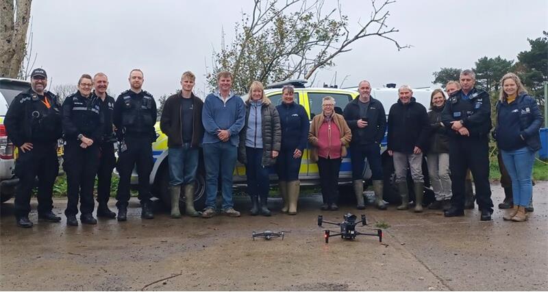 Farmers and police in front of a drone