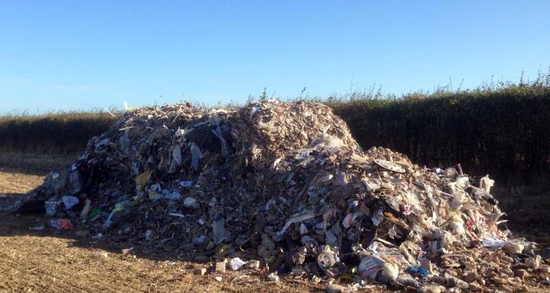 An image of fly-tipped waste on farming land