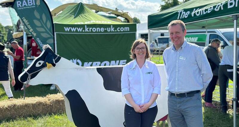 A photo of Northumberland County Adviser Anna Simpson and NFU North Regional Policy Manager Adam Briggs stood outside the NFU stand at Northumberland County Show
