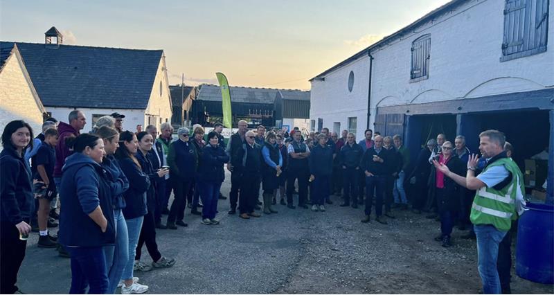 A photo of attendees of the Cheshire Chair farm walk in the farm yard listening to a speaker