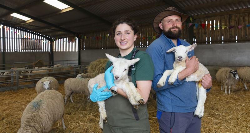 Martha and George Gilman holding lambs