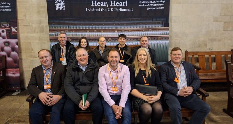 NFU members and staff sat on a bench within Parliament