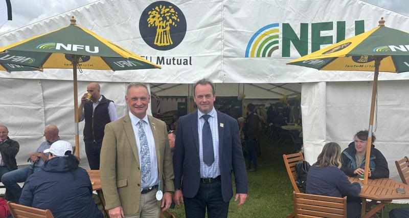A photo of David Hall and John Longmire stood in front of the NFU tent at Westmorland Show