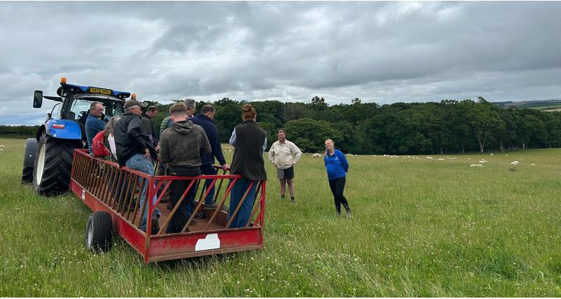 A photo of members on a trailer, touring a field at Rich and Jen Oglesby's farm
