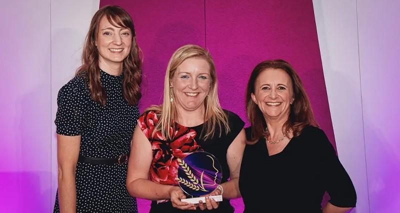 Milly Fyfe holding her award beside the Nestlé sponsor and comedian Lucy Porter