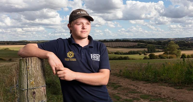 Young farmer Jack Meadows in a field after harvest