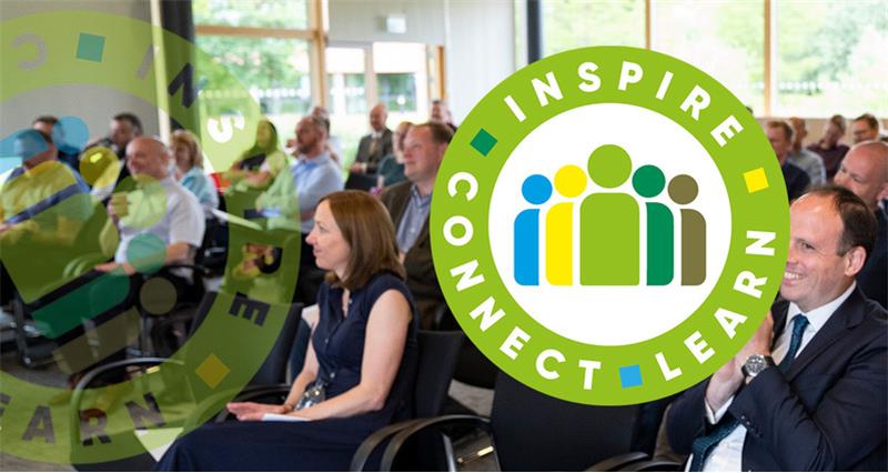 NFU Develops logo superimposed over a photograph of an audience at NFU HQ