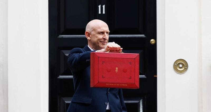 John Healey holding the Budget briefcase. Photograph: HM Treasury. Picture by Kirsty O'Connor / No 10 Downing Street.