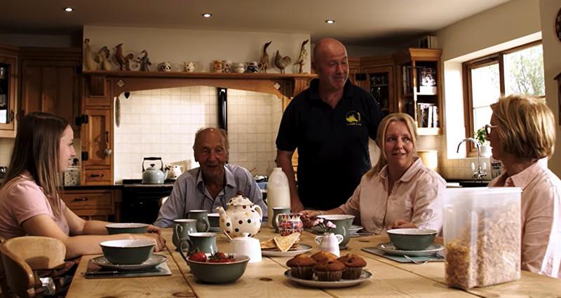 A family sits at a dining table