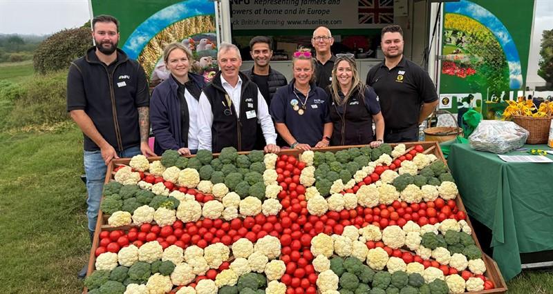 NFU stand team stood with a Union Jack food exhibit