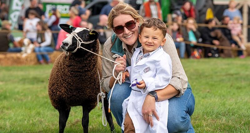 Young boy with a sheep at the West Grinstead and District Ploughing Match and Agricultural Show