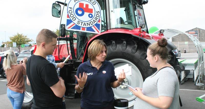 NFU Cheshire County Adviser Helen Wainwright promotes the Red Tractor logo to shoppers in Manchester_37274